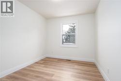 Empty room with light wood-style flooring and baseboards - 