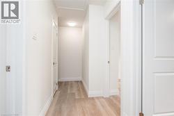 Hall featuring light wood finished floors and baseboards - 