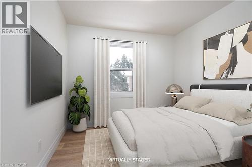 Bedroom featuring wood finished floors and baseboards - 27 Queenston Drive, Kitchener, ON - Indoor Photo Showing Bedroom