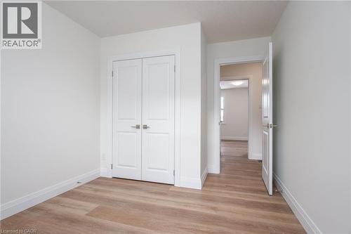 Unfurnished bedroom featuring light wood-type flooring and a closet - 27 Queenston Drive, Kitchener, ON - Indoor Photo Showing Other Room