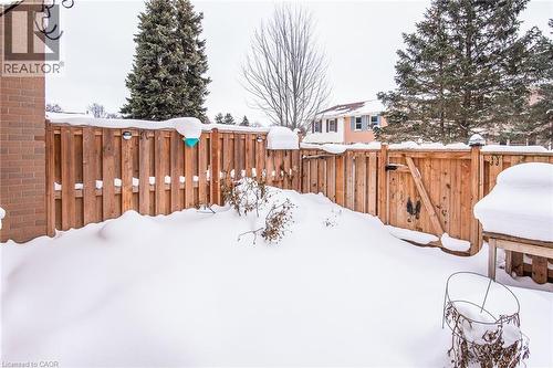 Yard layered in snow featuring a fenced backyard and a gate - 27 Queenston Drive, Kitchener, ON - Outdoor