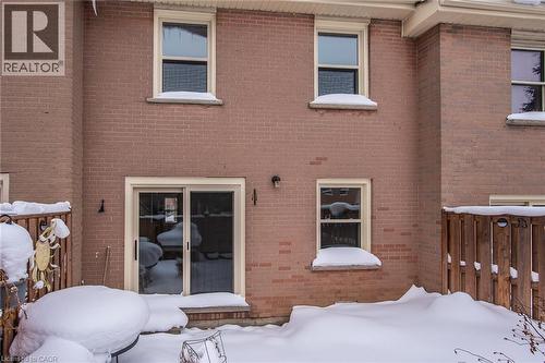 Snow covered house with brick siding - 27 Queenston Drive, Kitchener, ON - Outdoor With Exterior