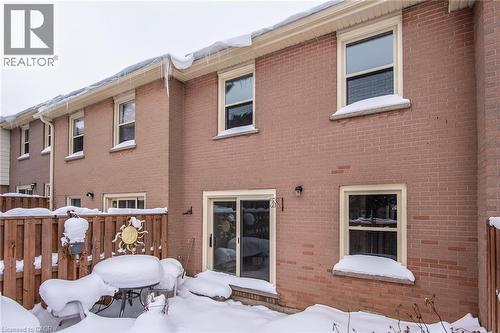 Snow covered property with brick siding - 27 Queenston Drive, Kitchener, ON - Outdoor With Exterior