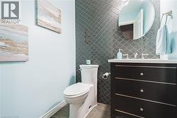 Half bathroom featuring tile walls and vanity - 
