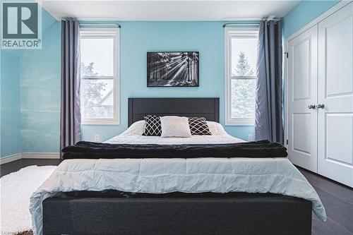 Bedroom with dark wood-type flooring, a closet, vaulted ceiling, and multiple windows - 25 Orchard Hill, Hamilton, ON - Indoor Photo Showing Bedroom