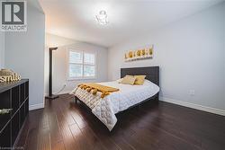 Bedroom featuring dark wood-style flooring - 