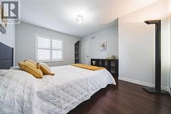 Bedroom with wood finished floors and baseboards - 