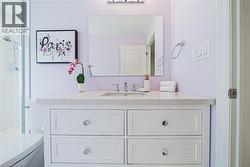 Full bath featuring vanity and tiled shower - 