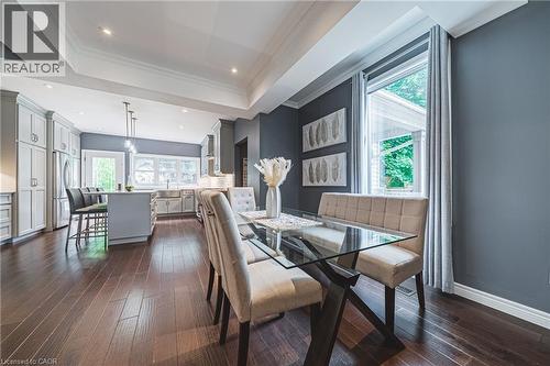Dining space with a raised ceiling, dark wood finished floors, crown molding, and recessed lighting - 25 Orchard Hill, Hamilton, ON - Indoor Photo Showing Dining Room