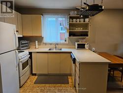 Galley kitchen w/dishwasher, pot rack, open shelf - 