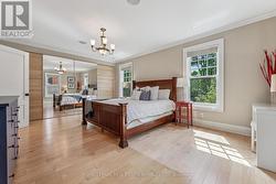 Bright Primary Bedroom Offering Hardwood Flooring - 