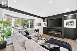 Large bay window & bold black accent wall. - 