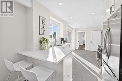 Breakfast bar & quartz countertops in kitchen. - 