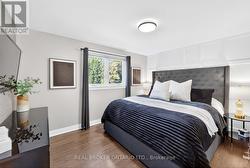 Primary bedroom with wainscoting accent wall. - 