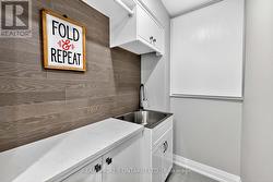 Laundry room with crawl space & utility sink. - 