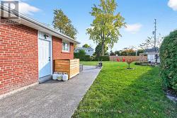 Side yard with garage access door. - 