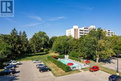 Aerial view of a pool and adjacent grass/park area - 
