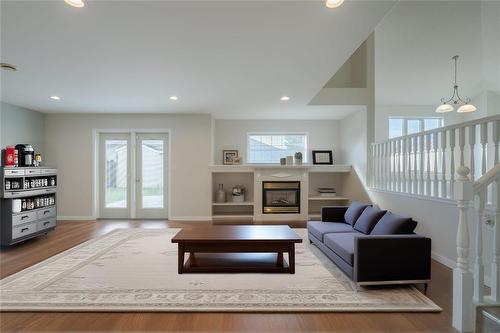 virtually staged - 2 Parkside Place, Steinbach, MB - Indoor Photo Showing Living Room With Fireplace