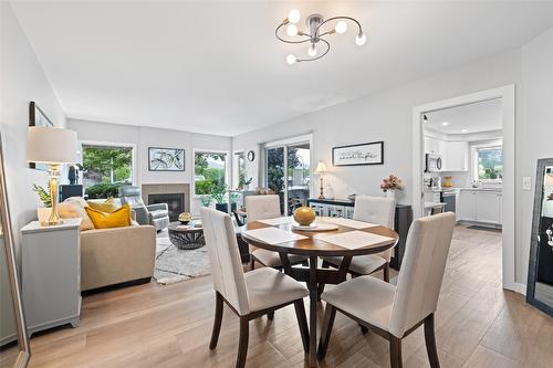 115-3335 Richter Street, Kelowna, BC - Indoor Photo Showing Dining Room With Fireplace