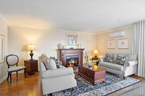 Living Room - 506-4460 Ch. Des Cageux, Laval (Chomedey), QC - Indoor Photo Showing Living Room With Fireplace