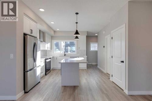 315 Fireside Drive, Cochrane, AB - Indoor Photo Showing Kitchen With Upgraded Kitchen