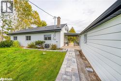 Rear view of house featuring a lawn and central air condition unit - 