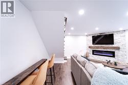 Living room featuring a fireplace and dark hardwood / wood-style flooring - 