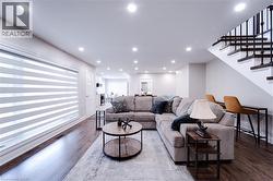 Living room with hardwood / wood-style flooring - 