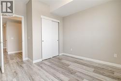 Unfurnished bedroom with a closet and light wood-style floors - 