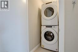 Laundry Closet in unit entrance with stacked washer / drying machines - 
