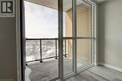 Doorway to outside with baseboards and wood finished floors - 