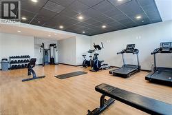 Workout area featuring a paneled ceiling and recessed lighting - 