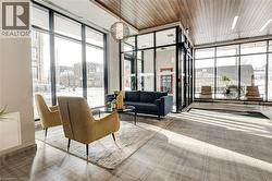 Community lobby featuring expansive windows and wooden ceiling - 