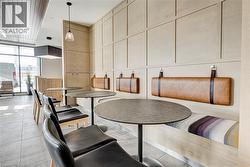 Dining room featuring a wall of windows and light tile patterned floors - 