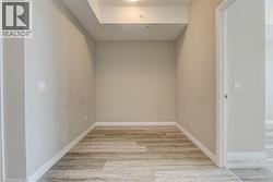 Unfurnished room with light wood-type flooring and baseboards - 
