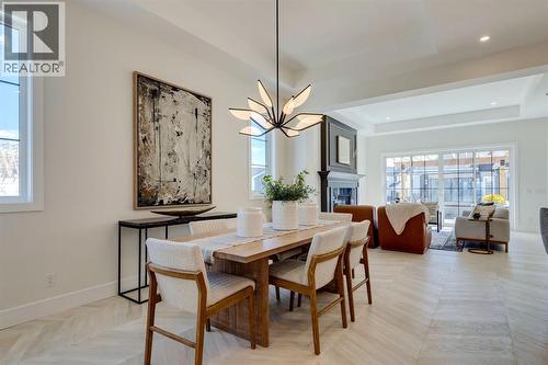 11 Normandy Lane Sw, Calgary, AB - Indoor Photo Showing Dining Room With Fireplace