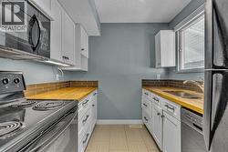 Kitchen with newer cabinets and wood counters - 