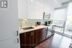 Kitchen with Hardwood & Floor-to-Ceiling Windows - 