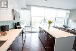Kitchen with Hardwood & Floor-to-Ceiling Windows - 