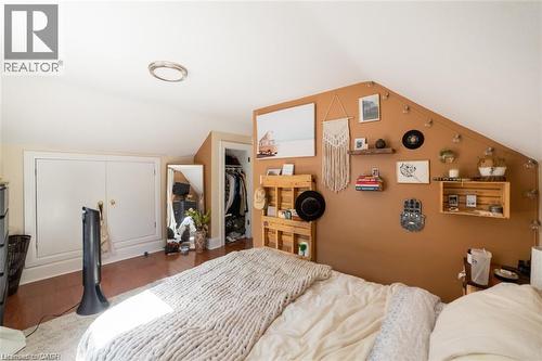 Bedroom featuring lofted ceiling, wood finished floors, and a walk in closet - 41 Paradise Road S, Hamilton, ON - Indoor Photo Showing Bedroom