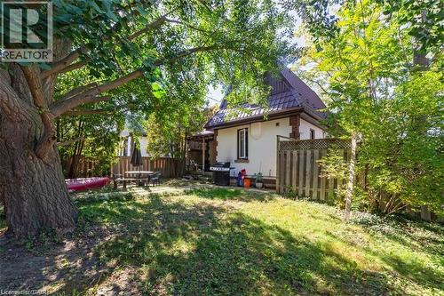 Rear view of house with a fenced backyard, a patio, a standing seam roof, a metal roof, and stucco siding - 41 Paradise Road S, Hamilton, ON - Outdoor