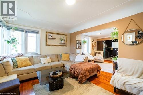 Living area featuring wood finished floors and arched walkways - 41 Paradise Road S, Hamilton, ON - Indoor Photo Showing Living Room