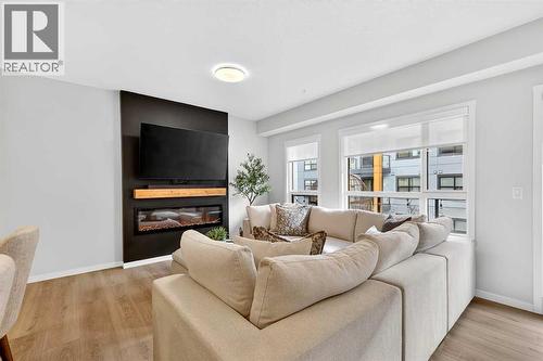 6205, 20295 Seton Way Se, Calgary, AB - Indoor Photo Showing Living Room With Fireplace