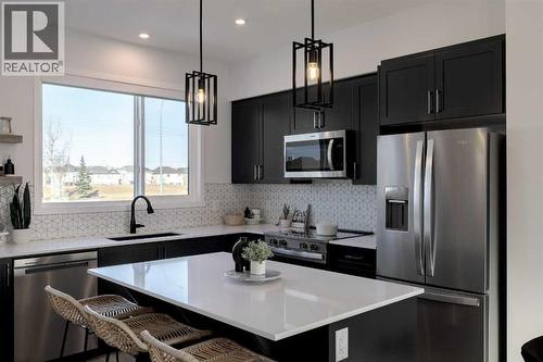 209, 81 Midtown Boulevard Sw, Airdrie, AB - Indoor Photo Showing Kitchen With Upgraded Kitchen