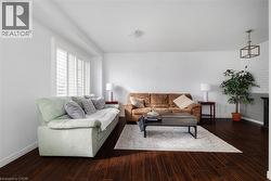 Living room with baseboards and dark wood-type flooring - 
