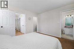 Bedroom with light colored carpet and ensuite bath - 
