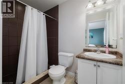 Bathroom featuring vanity, a stall shower, and light tile patterned flooring - 