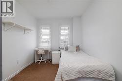 Bedroom featuring carpet flooring and a desk - 