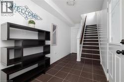 Stairs featuring baseboards and tile patterned flooring - 