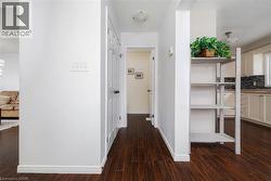 Hallway featuring dark wood-style floors and a textured ceiling - 